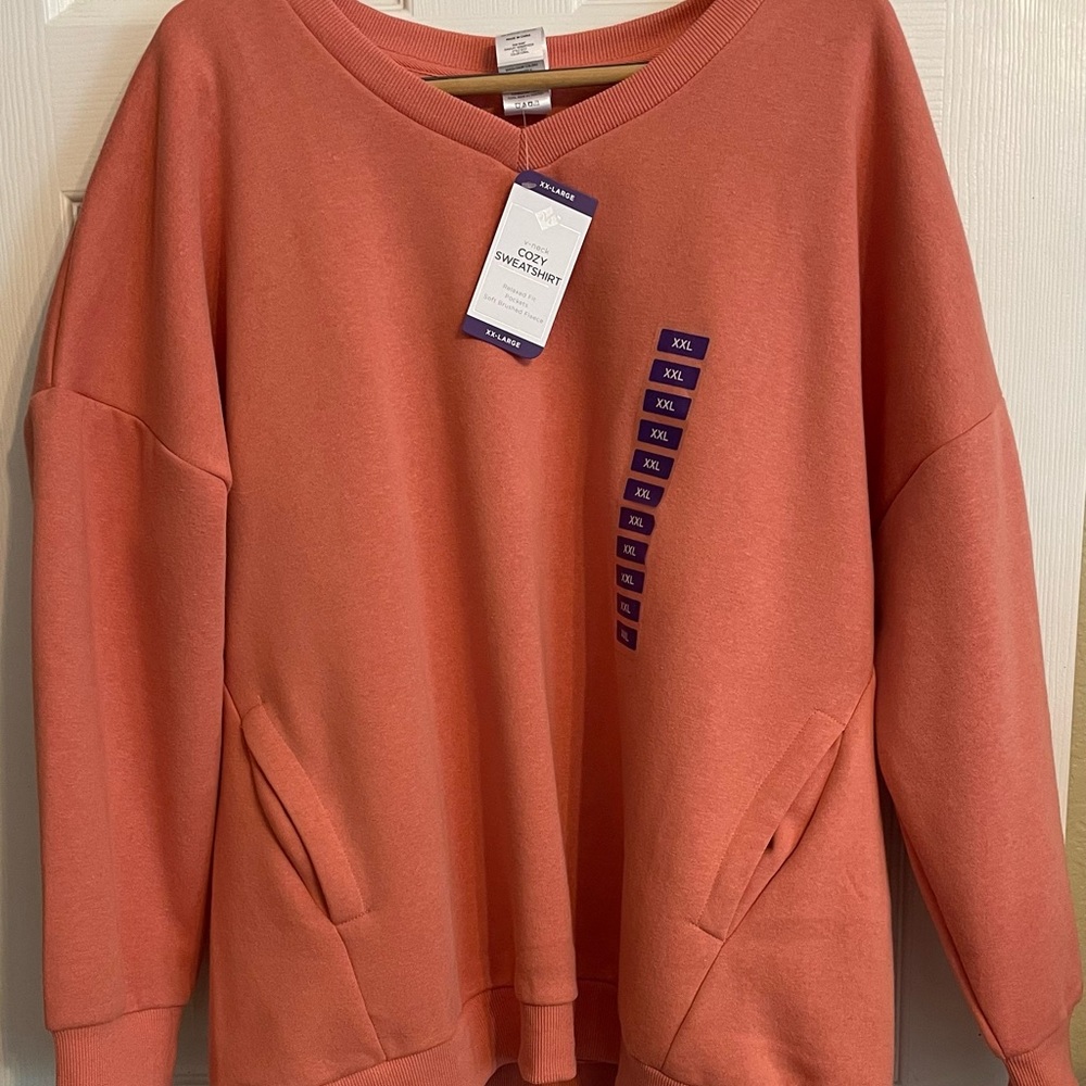 NWT Sweatshirt with pockets. Coral-Peach in color.